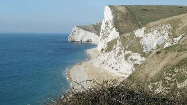A coastal landscape with white cliffs and a sandy beach. - George Albert Hotel & Spa (Dorchester)