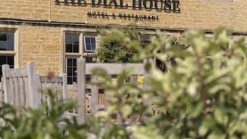 A stone building with a sign reading "The Dial House Hotel & Restaurant".