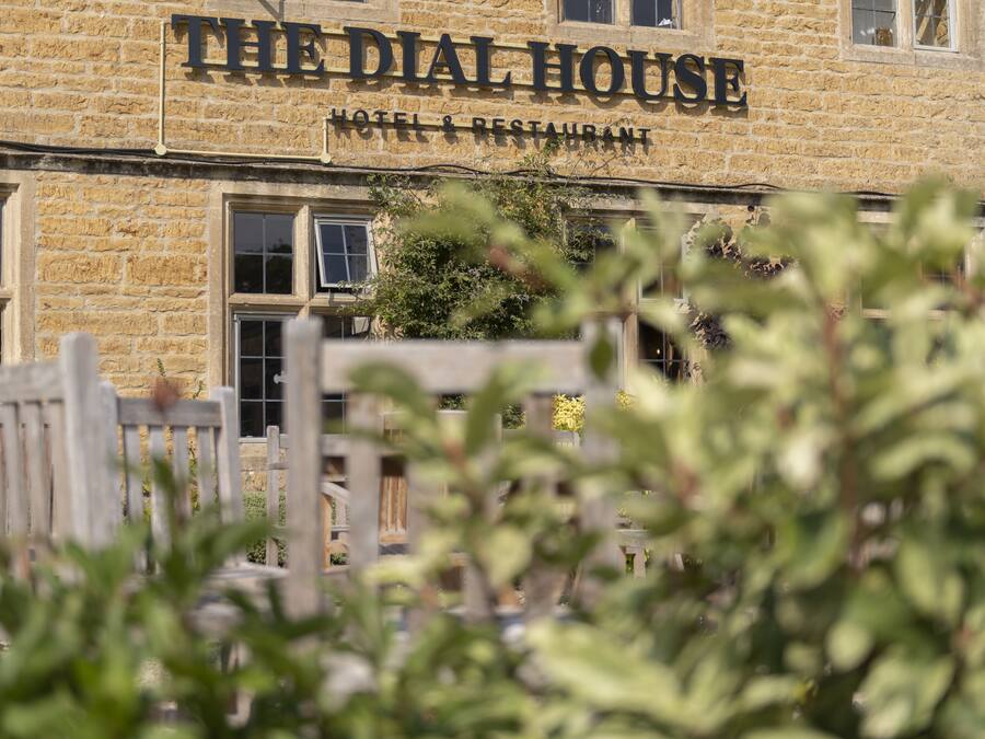 A stone building with a sign reading "The Dial House Hotel & Restaurant".
