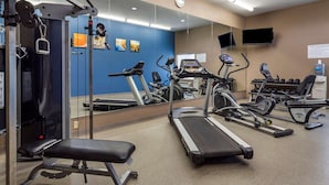 A gym with treadmills, weight machines, and a bench. - Comfort Inn & Suites Cleveland TX (Cleveland)