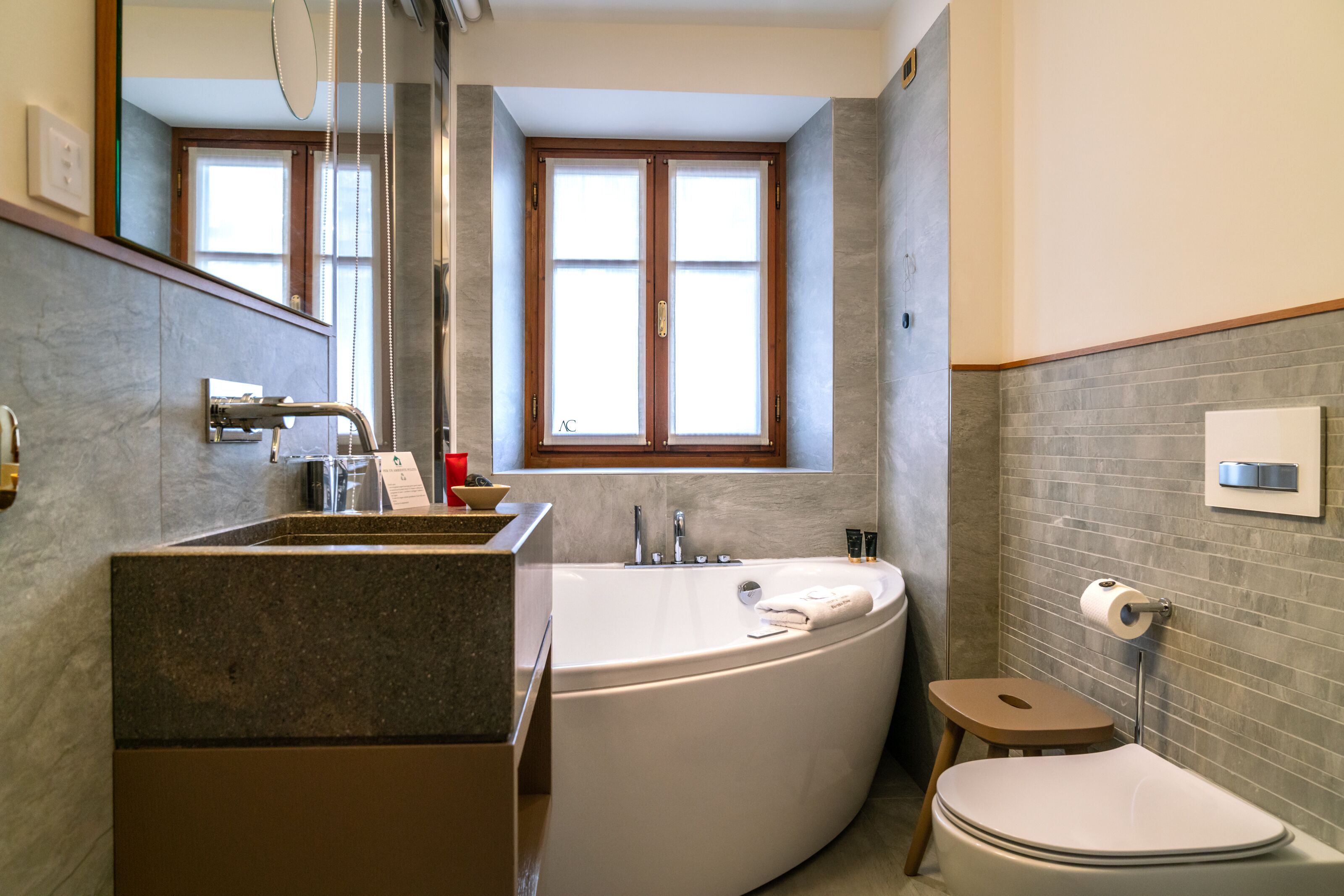 A modern bathroom with a freestanding bathtub, a sink, and a toilet.