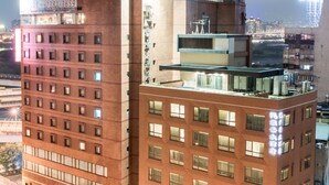 A multi-story building with a prominent corner, large windows, and a flat roof. - Hotel Riverview Taipei (Taipei)