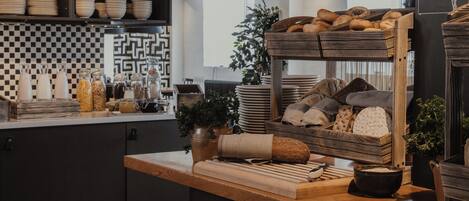 A bakery counter with bread, pastries, and jars of ingredients.