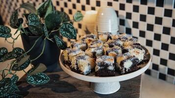 A dessert plate with a checkered tile wall in the background.