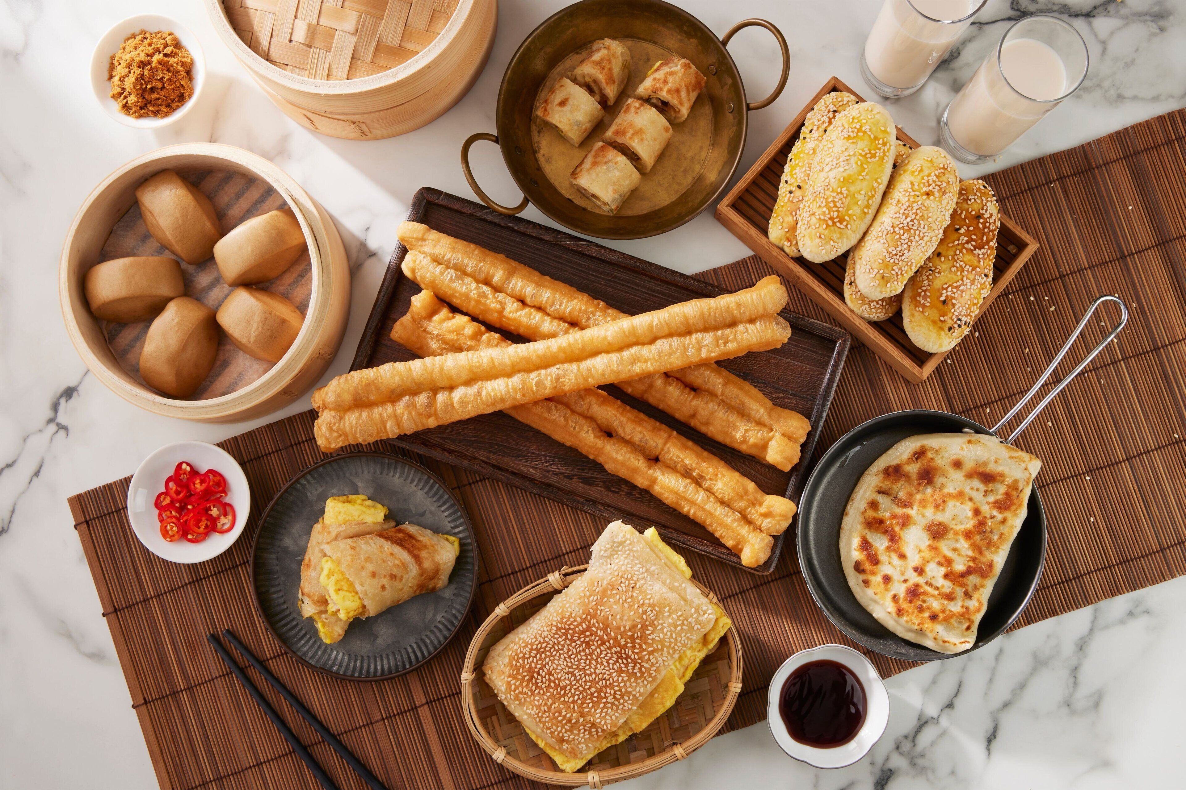 A variety of Asian snacks and beverages arranged on a table.