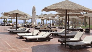 A beachside resort with sun loungers and thatched umbrellas. -  Three Corners Sea Beach Resort (El Quseir)
