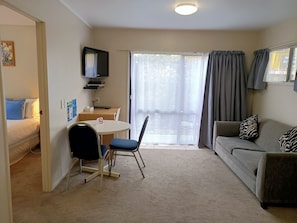 10. Deluxe One Bedroom | Living area | 32-inch flat-screen TV with cable channels, TV