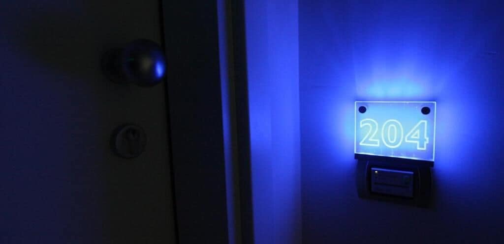 A door with a blue-lit number plate displaying '204'.