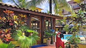 A reception area with a pool and tropical plants.