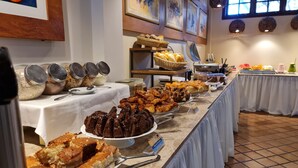A buffet with various food items and condiments.
