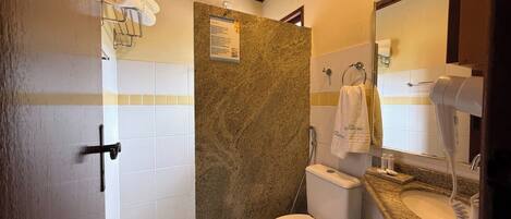 A bathroom with a shower, toilet, and sink.