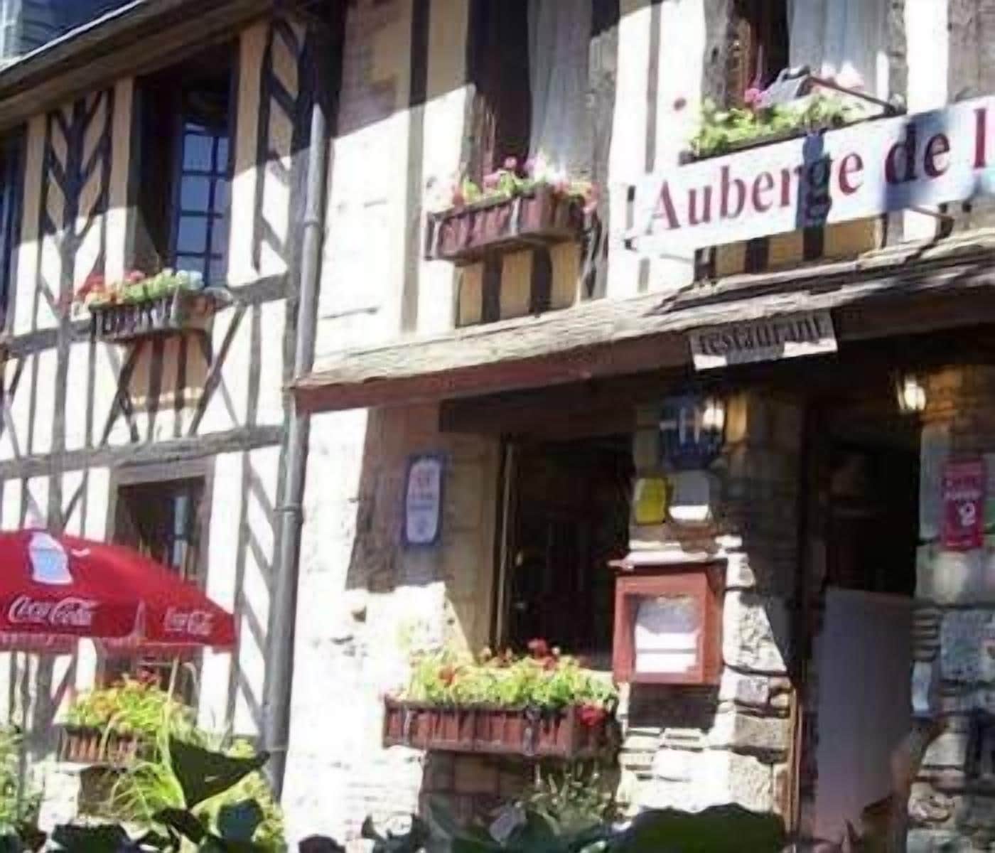 A traditional half-timbered building with a sign reading "Auberge de l'."