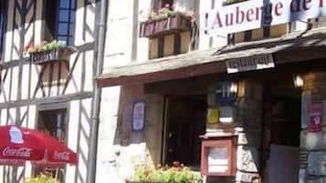 A traditional half-timbered building with a sign reading "Auberge de l'."