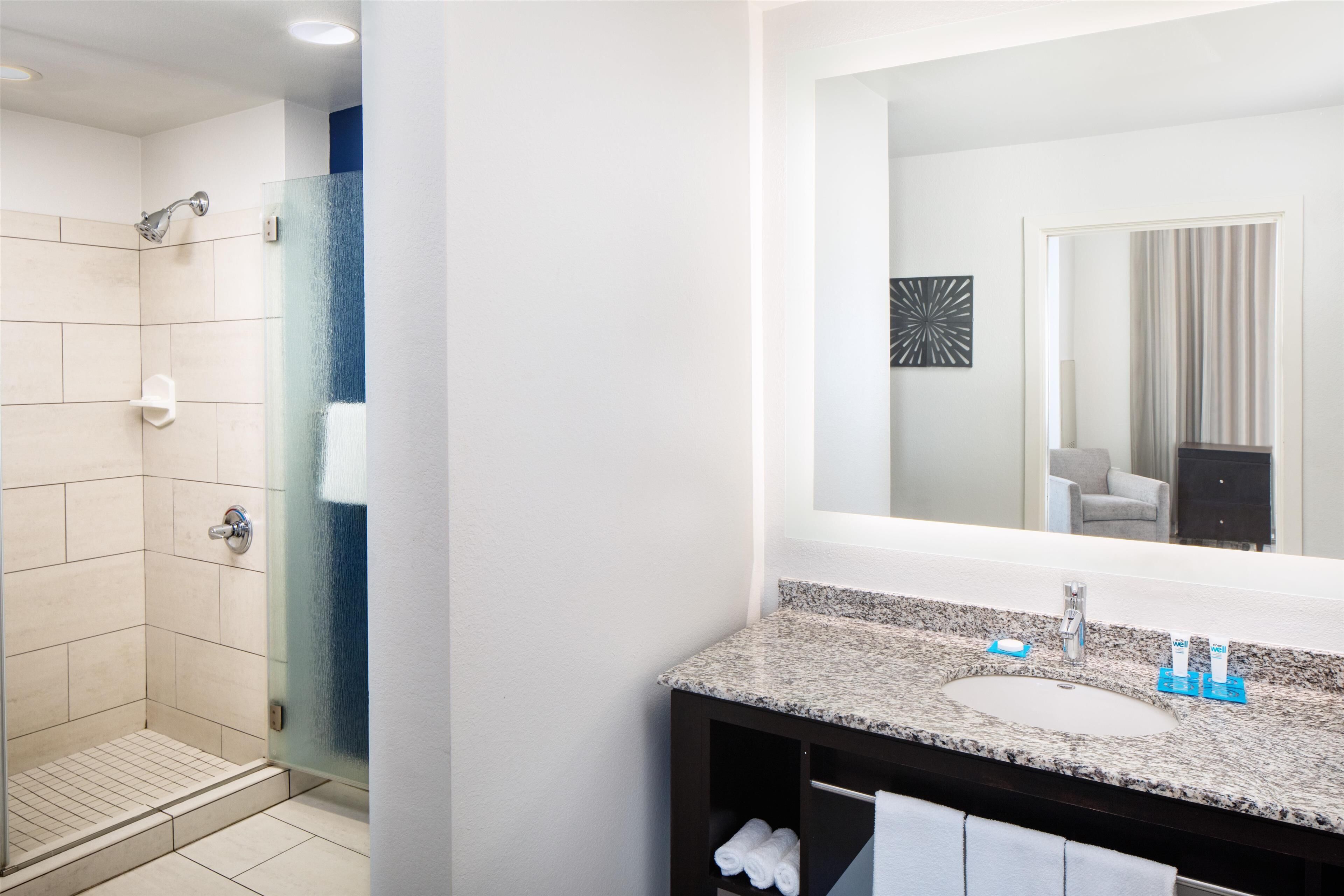 designer toiletries, hair dryer, towels, soap