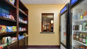 A hotel pantry with shelves stocked with snacks and beverages. - Hampton Inn Muscatine (Muscatine)