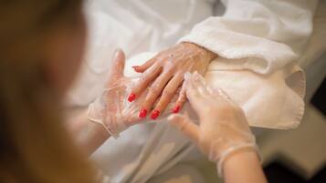 A person wearing gloves, holding a white cloth.