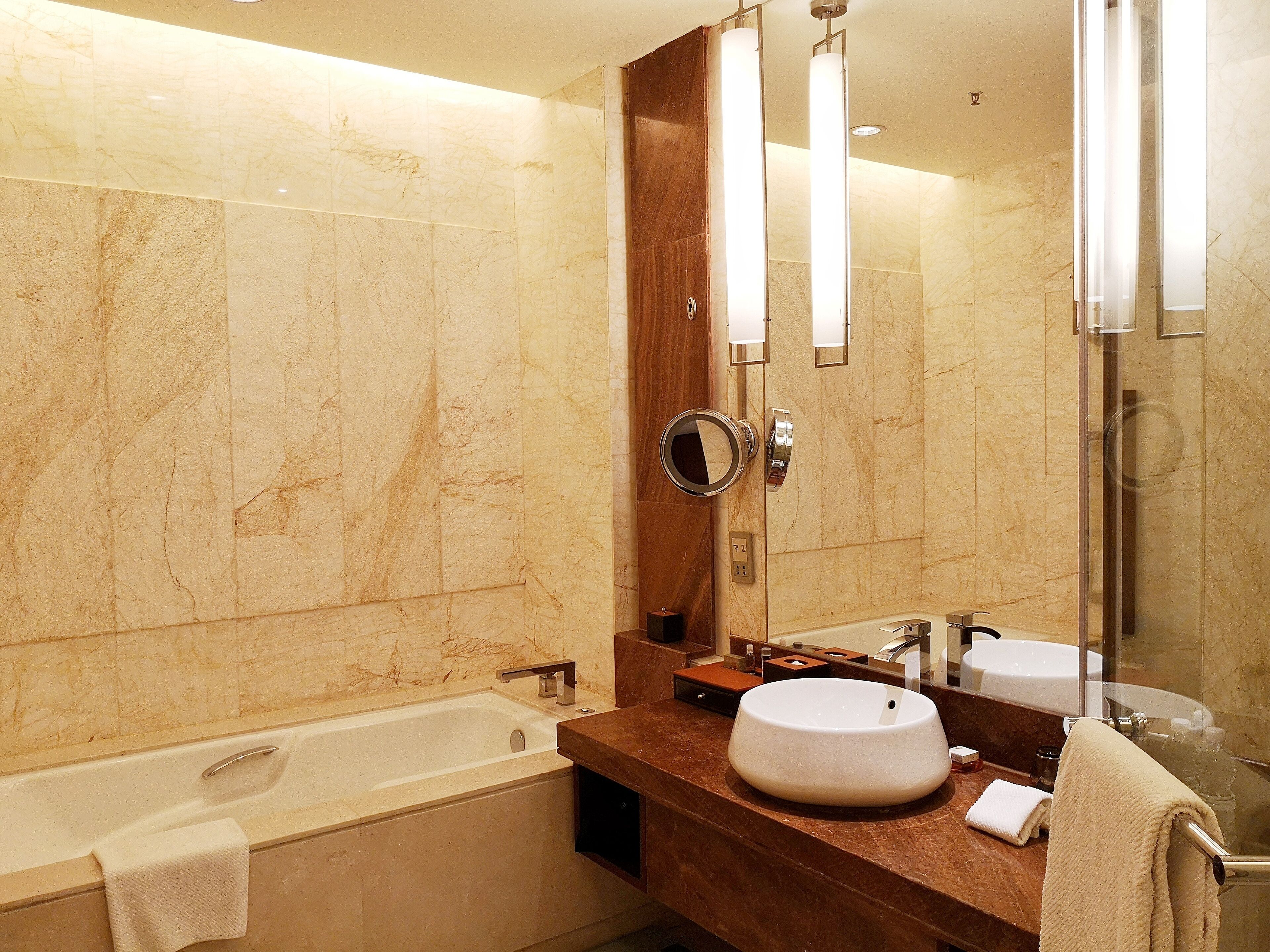 separate bathtub and shower, rainfall showerhead, designer toiletries