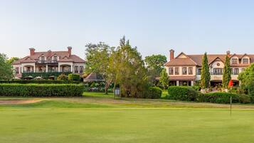 Stately homes stand amidst lush greenery and mature trees, offering a serene and atmosphere.