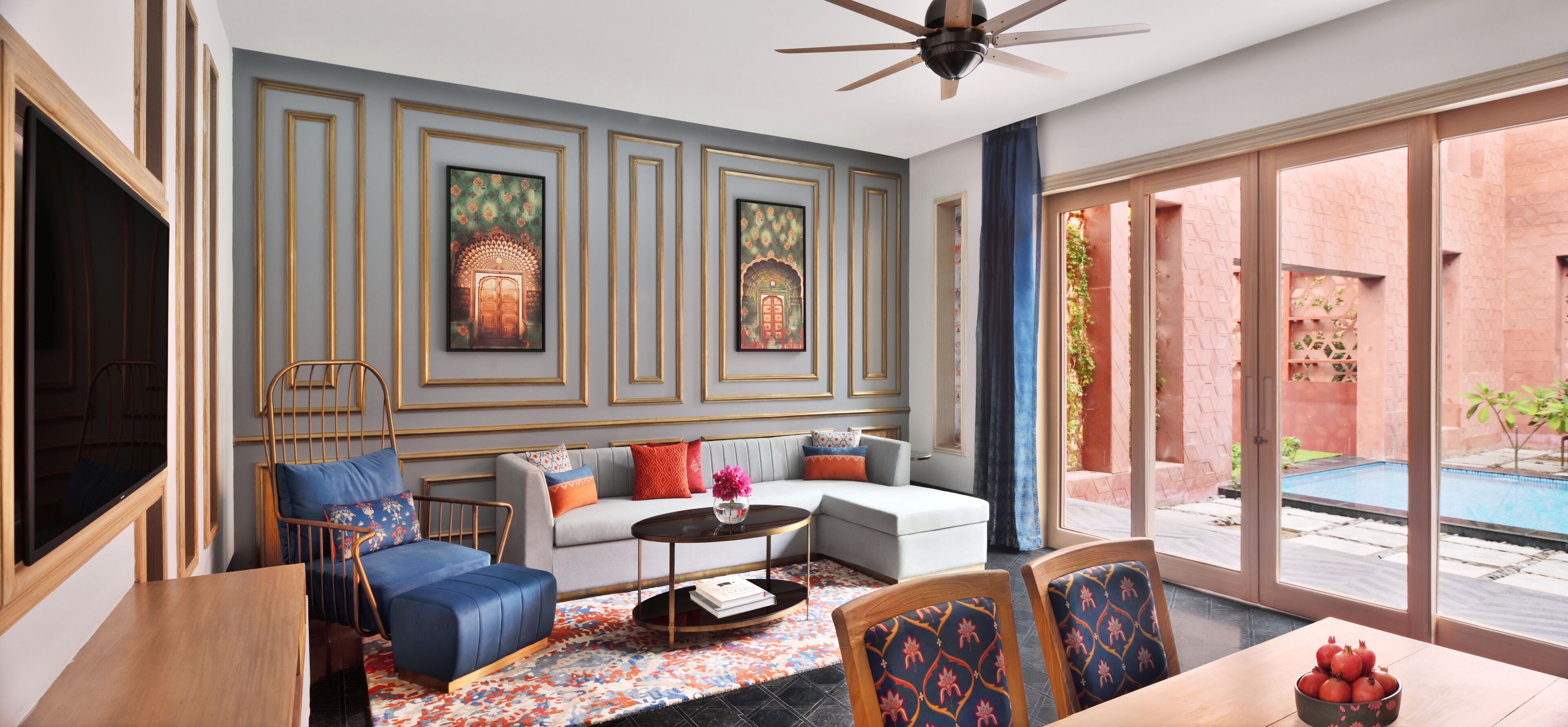 A modern living room with a sofa, chairs, a coffee table, and artwork on the walls.