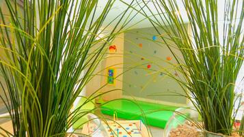 Playful space for kids, featuring a climbing wall and colorful puzzle.