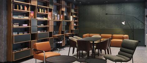 A modern library with bookshelves, seating, and tables.