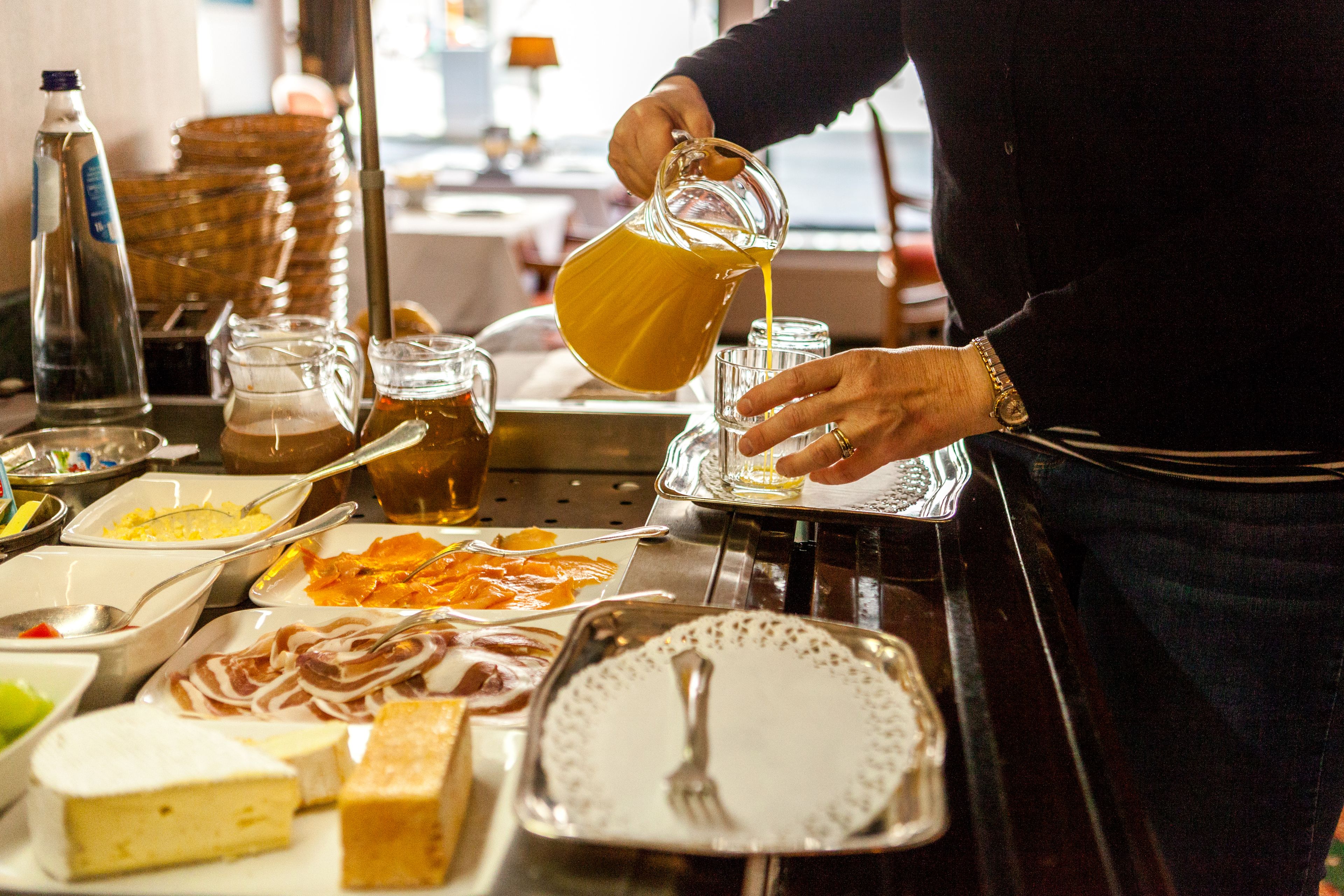 A buffet setup with various food items and beverages.