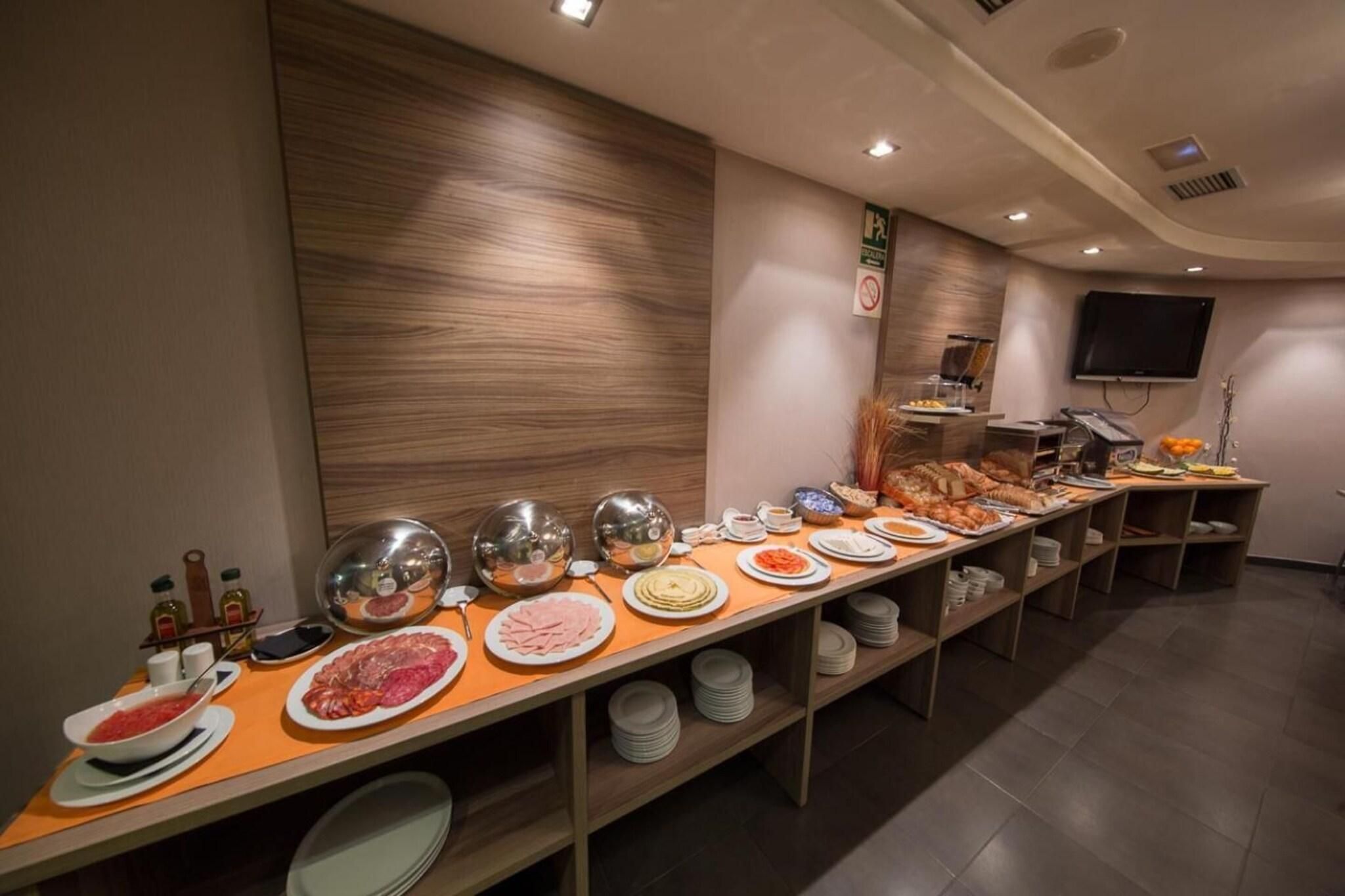 A buffet setup with various food items and condiments.
