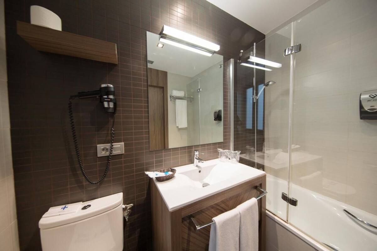 bathtub, designer toiletries, hair dryer, bidet