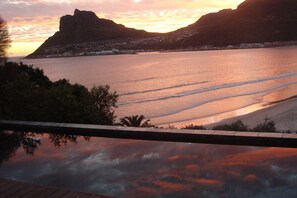 Outdoor pool, open 11 AM to 8 PM, pool umbrellas, pool loungers
