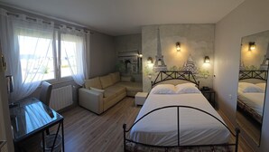 A bedroom with a bed, a sofa, a desk, and a window with curtains. - Hôtel Champ Alsace Aerodrome (Haguenau)