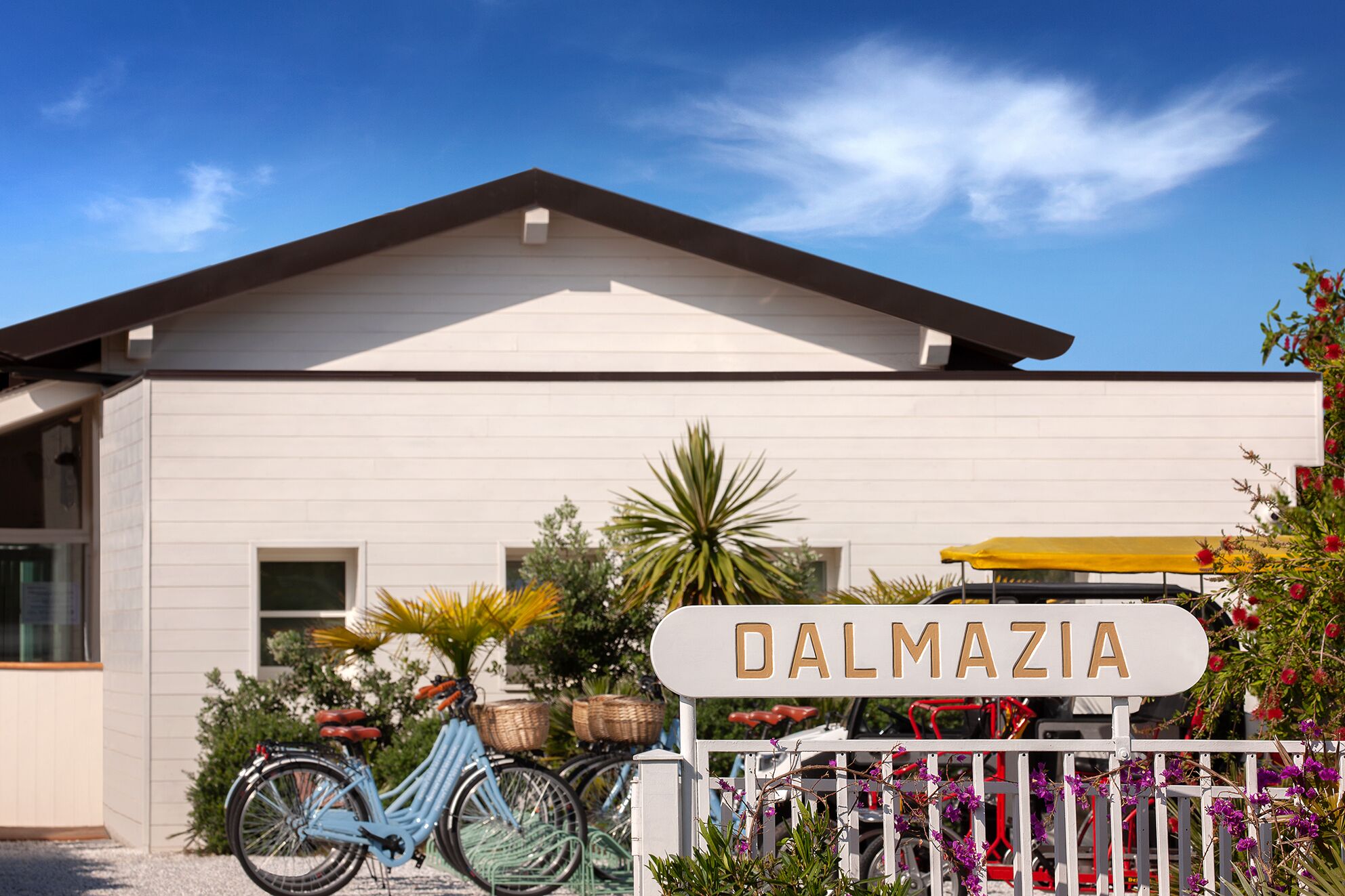 A building with a sign reading "DALMAZIA" in front.