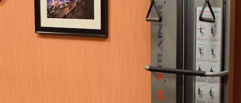 A hotel fitness center with a pull-up bar, exercise ball, and a bench.