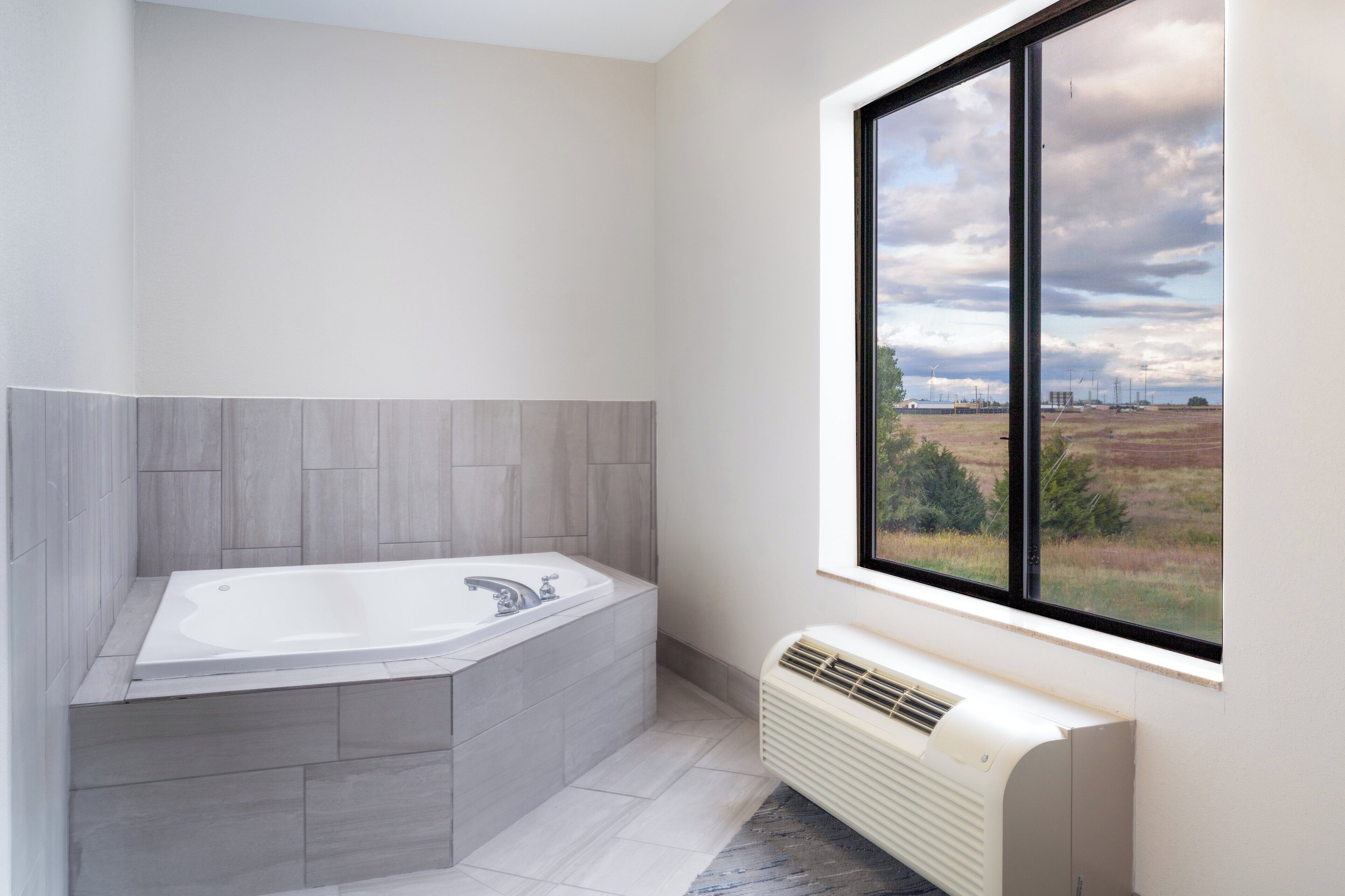 Suite, 1 King Bed, Jetted Tub | Bathroom | Hair dryer, towels