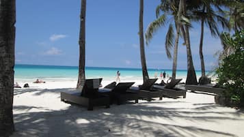On the beach, white sand, free beach cabanas, sun-loungers
