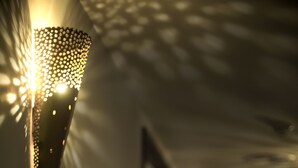 A hallway with a decorative light fixture on the left and a series of lights on the right. - Venue Hotel (Singapore)