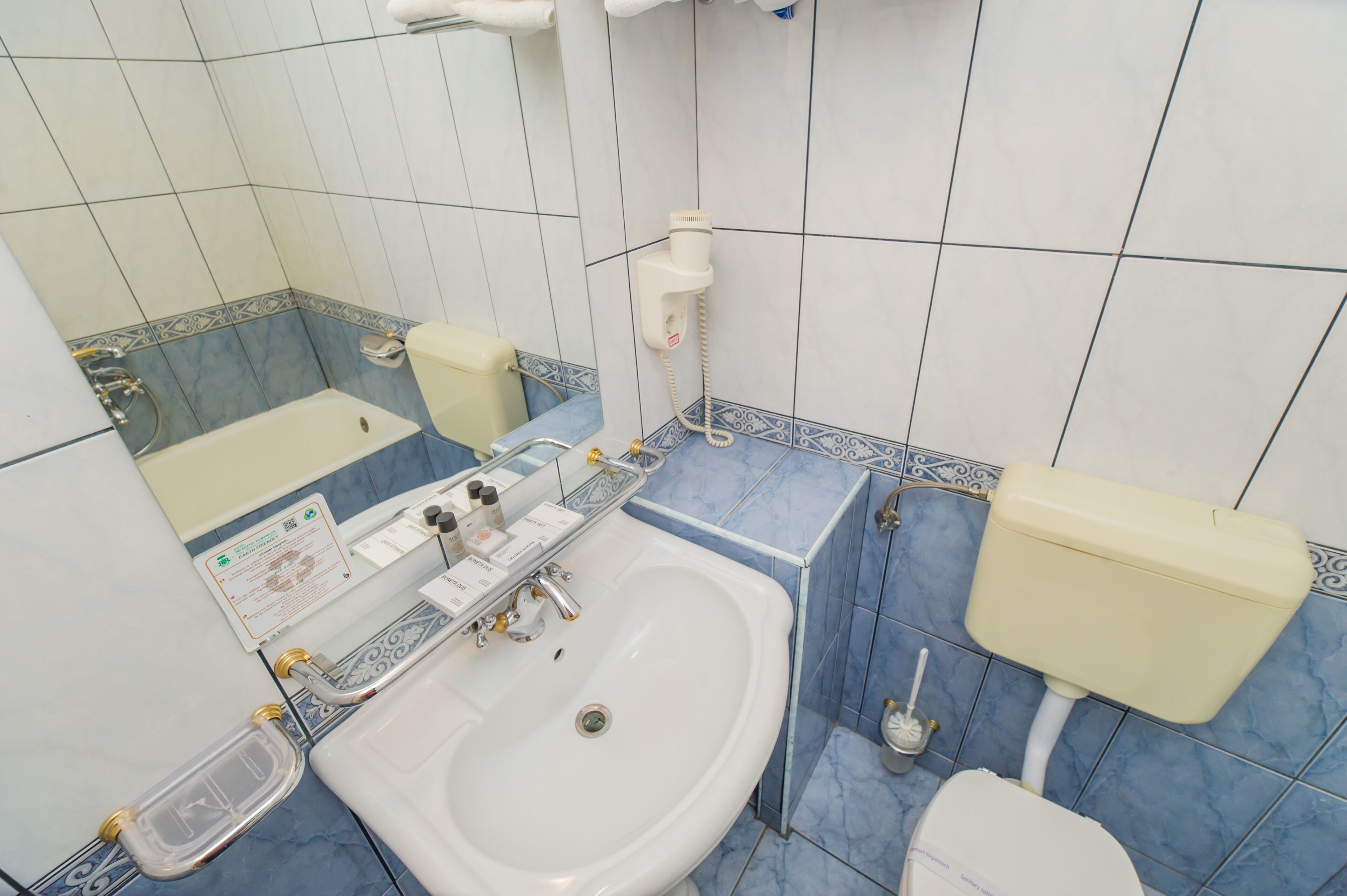 A bathroom with a sink, toilet, and bathtub.