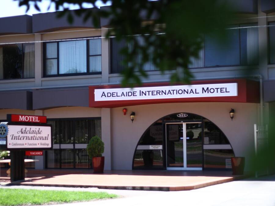 Adelaide International Motel with a signboard indicating it offers services for conferences, functions, and weddings.