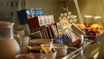 A breakfast buffet with various food items and beverages.