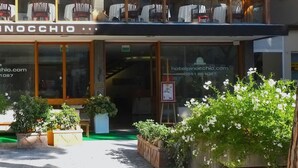Hotel Pinocchio with a clear entrance, potted plants, and a signboard. - Hotel Pinocchio (Cattolica)