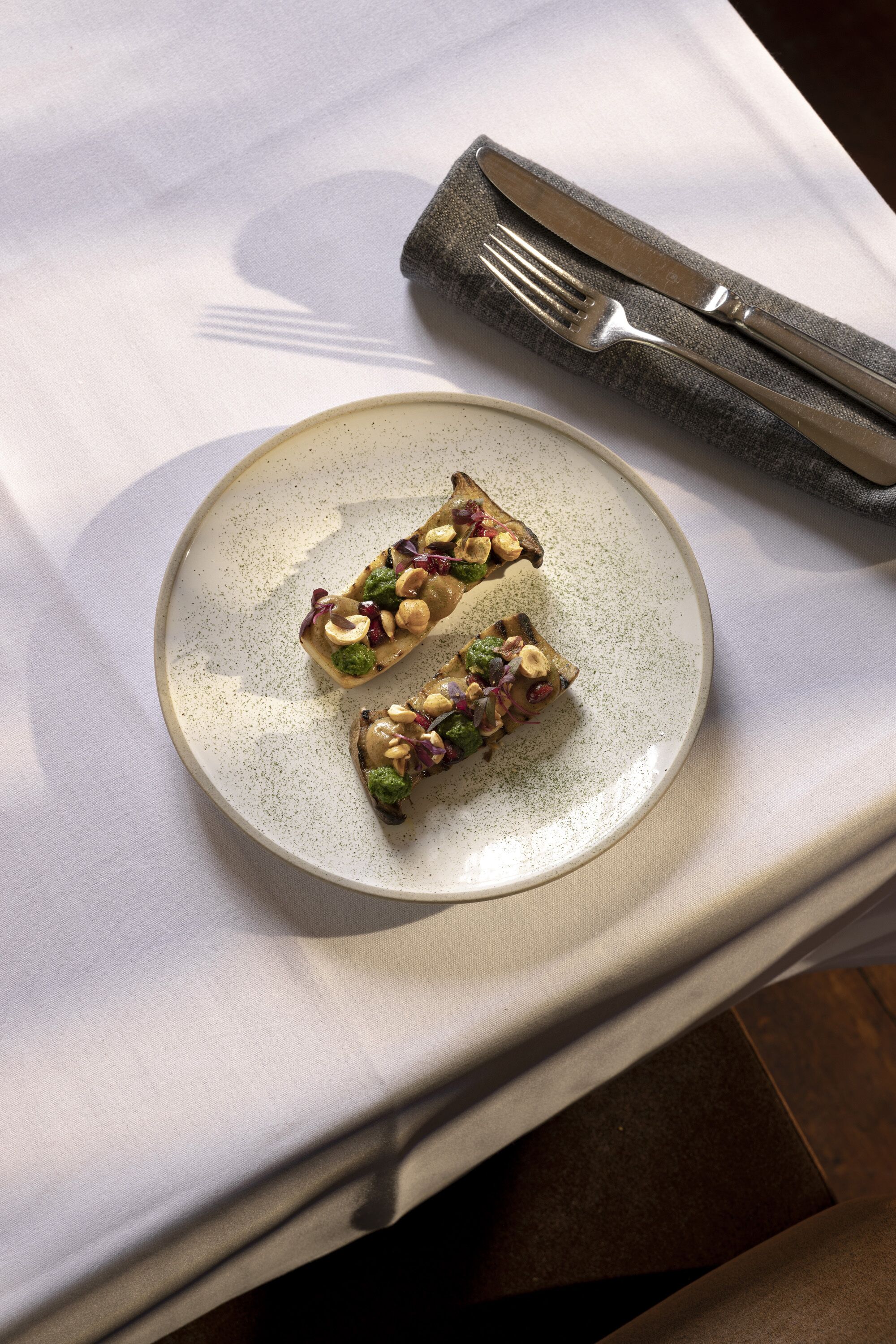 A plate with two pieces of food on a table.