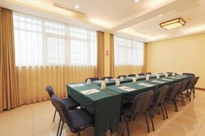 A conference room with a long table, chairs, and a window with curtains. - Grand Hotel Yuanshan (Beijing)