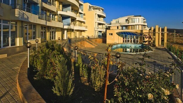 A modern hotel with multiple balconies, a swimming pool, and landscaped gardens. - Sunset Kosharitsa (KOSHARITSA)