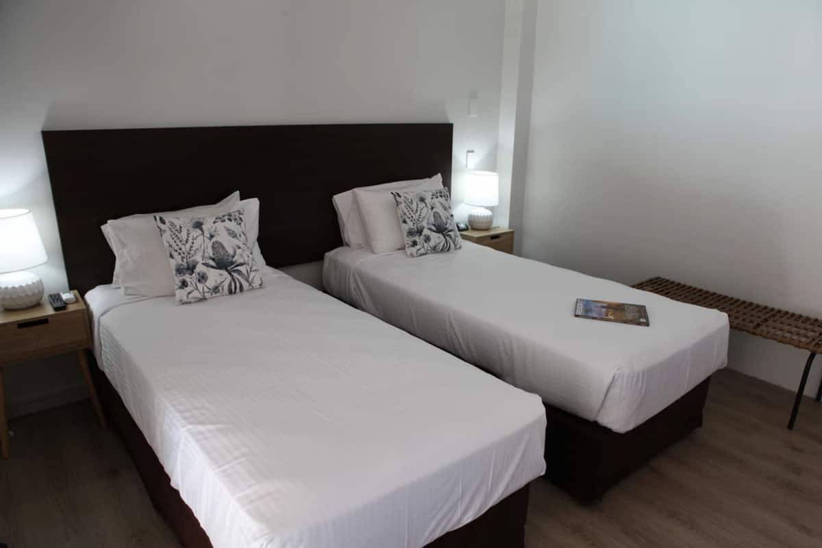 Desk, iron/ironing board, bed sheets