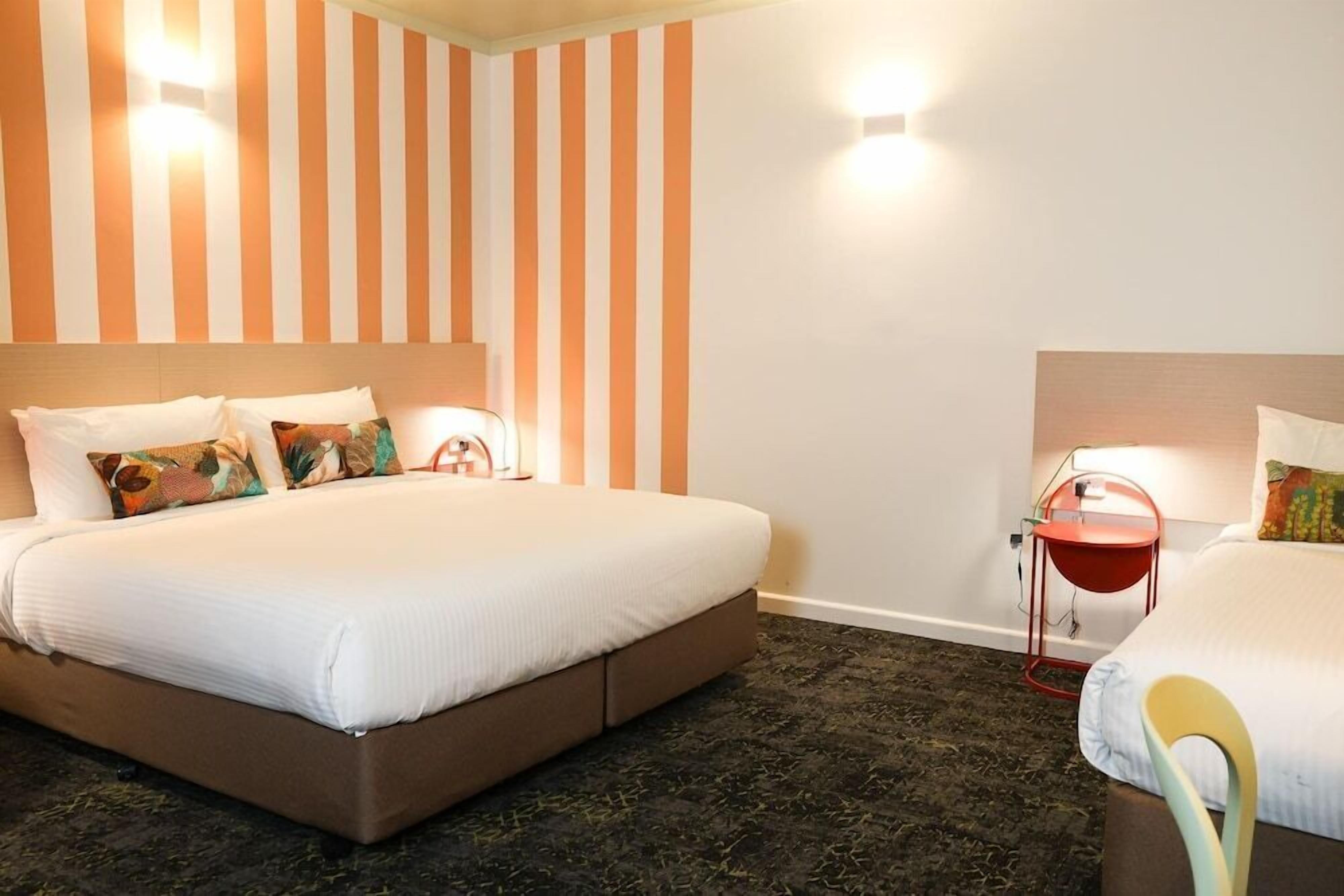 Desk, iron/ironing board, bed sheets