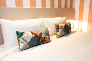 Desk, iron/ironing board, bed sheets