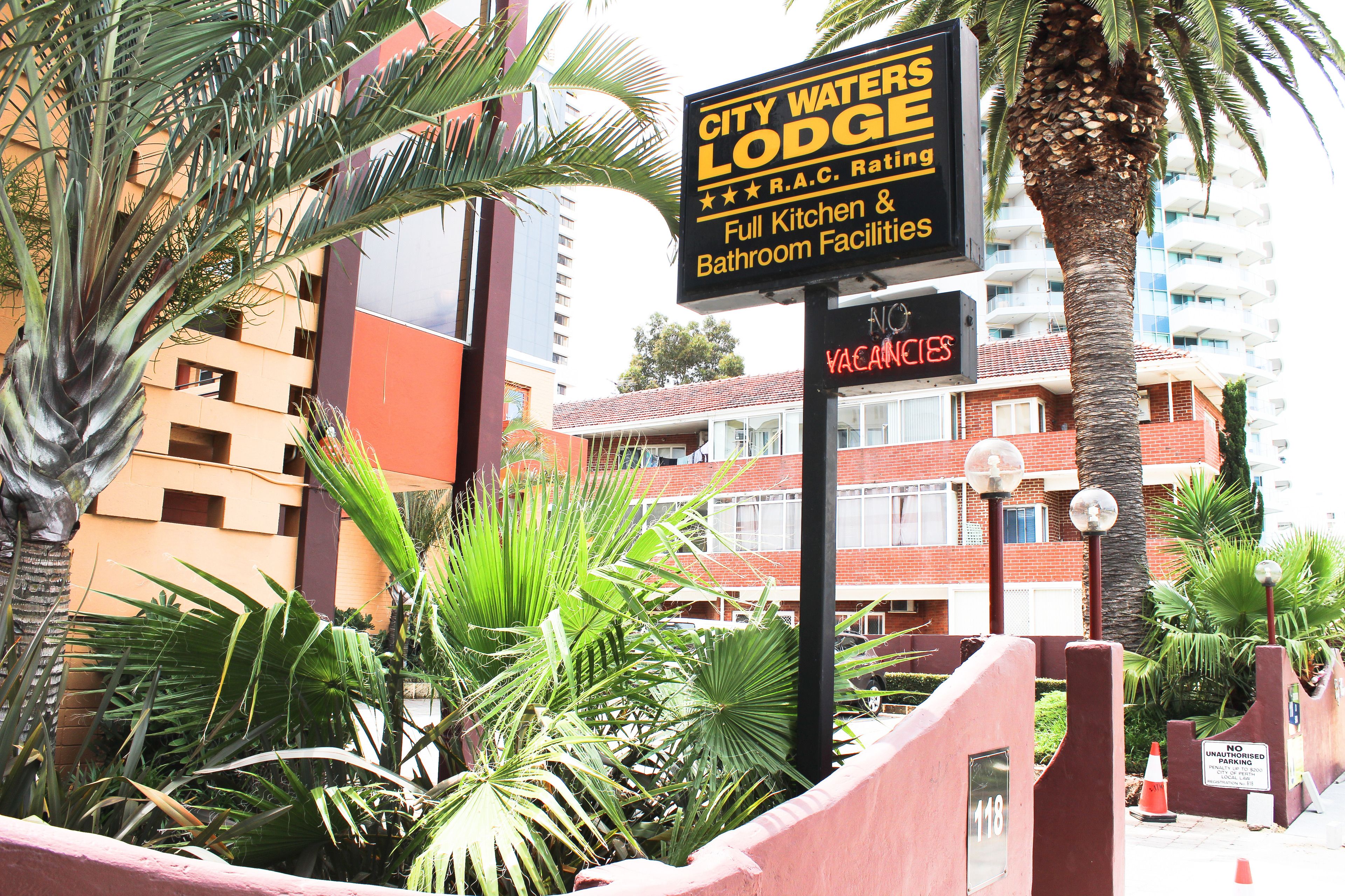 A sign for City Waters Lodge with amenities including full kitchen and bathroom facilities.