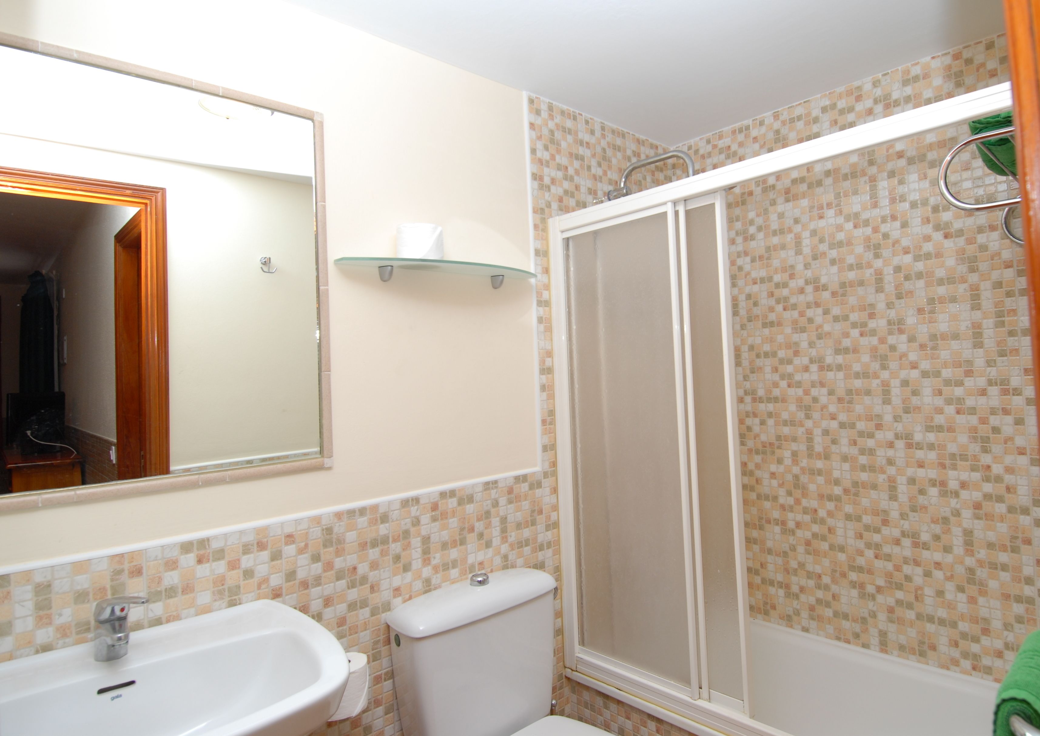 A bathroom with a sink, toilet, and shower.