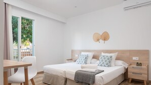 Een moderne slaapkamer met een bed, nachtkastjes, een bureau en een stoel.