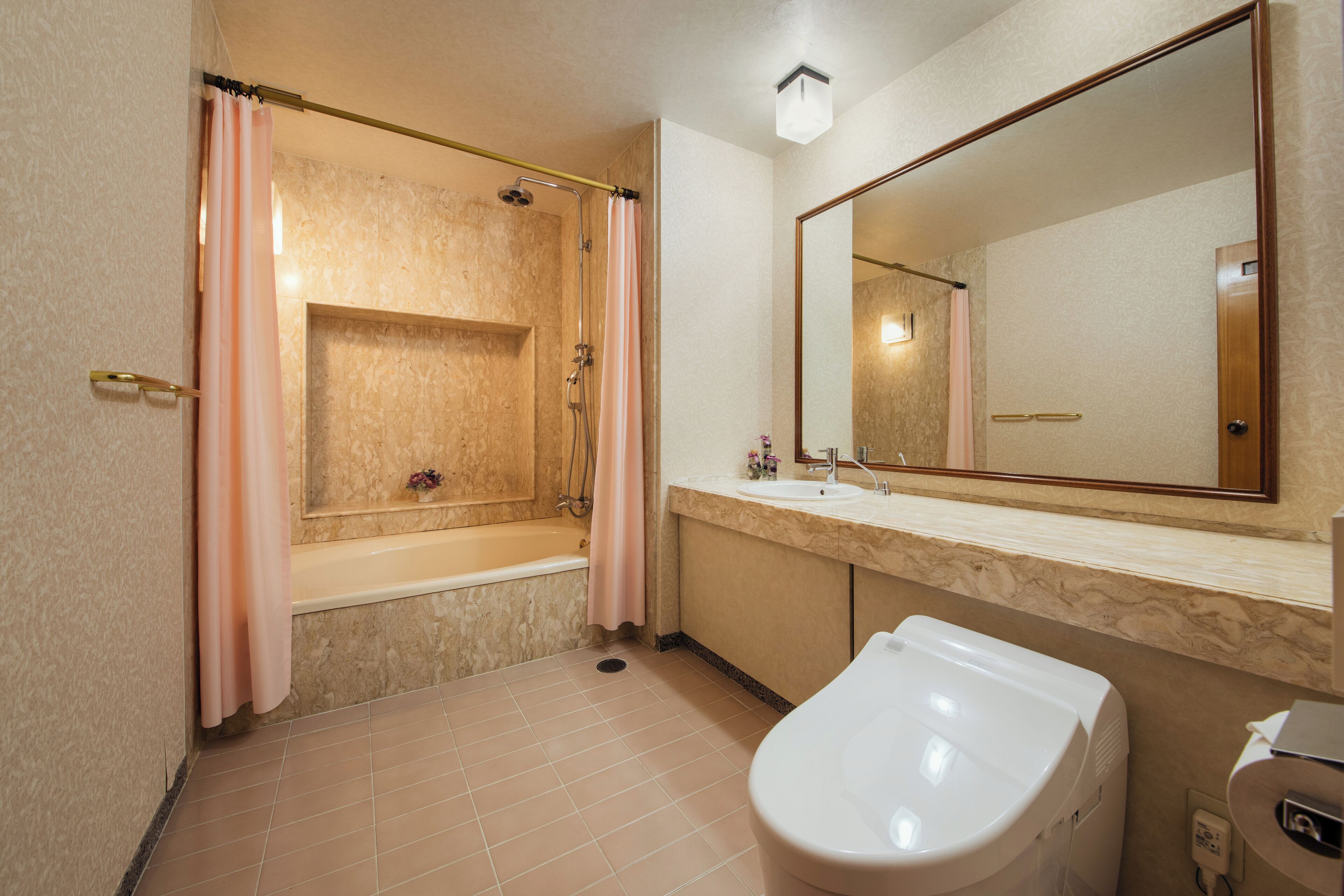 A bathroom with a bathtub, a shower, a toilet, and a sink.