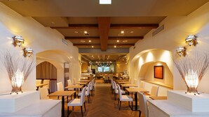 A spacious restaurant with high ceilings, wooden beams, and elegant wall sconces. Tables and chairs are arranged for dining. - Hotel Sunroute Sopra Kobe (Kobe)